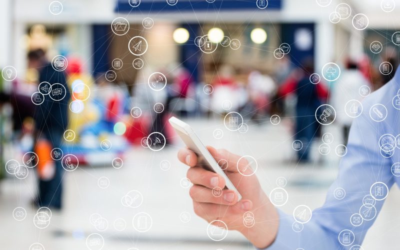 digital composite of hand holding smartphone with vignettes